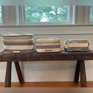 Set of four TARTAN+TWINE cosmetic bags.